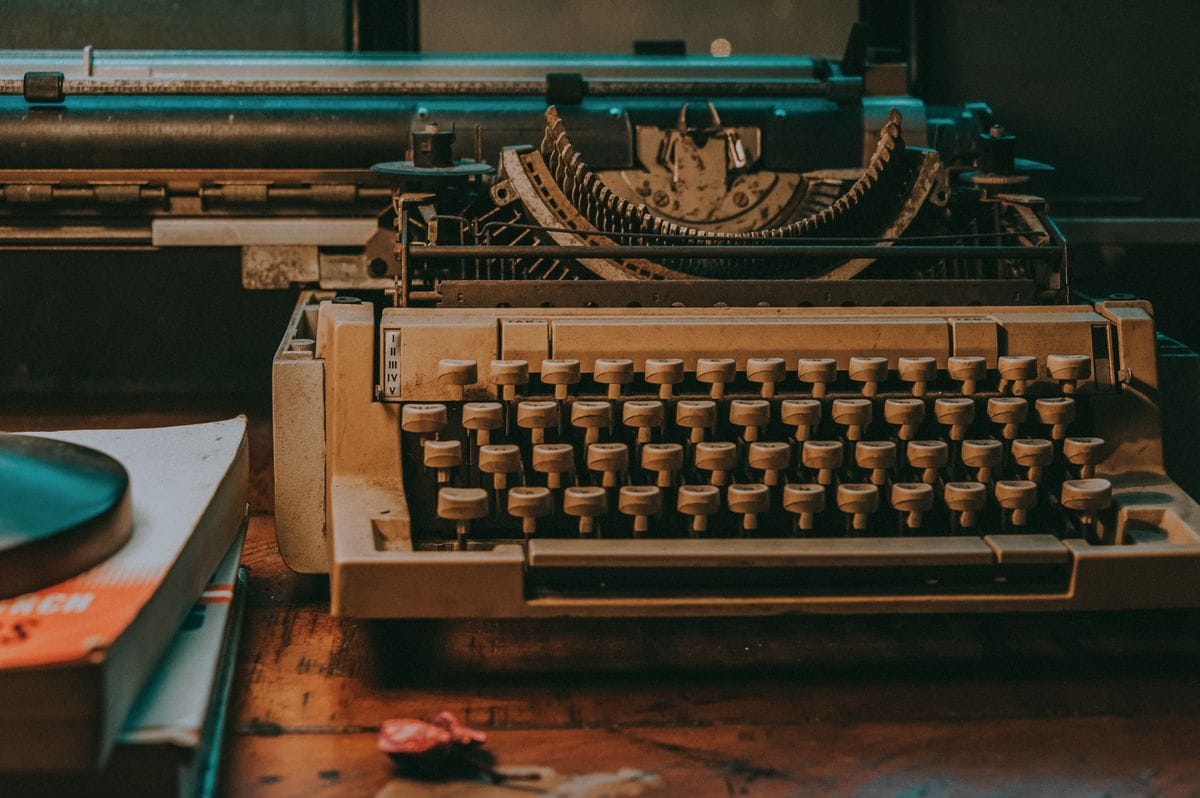 Close-up of a vintage typewriter on a wooden desk