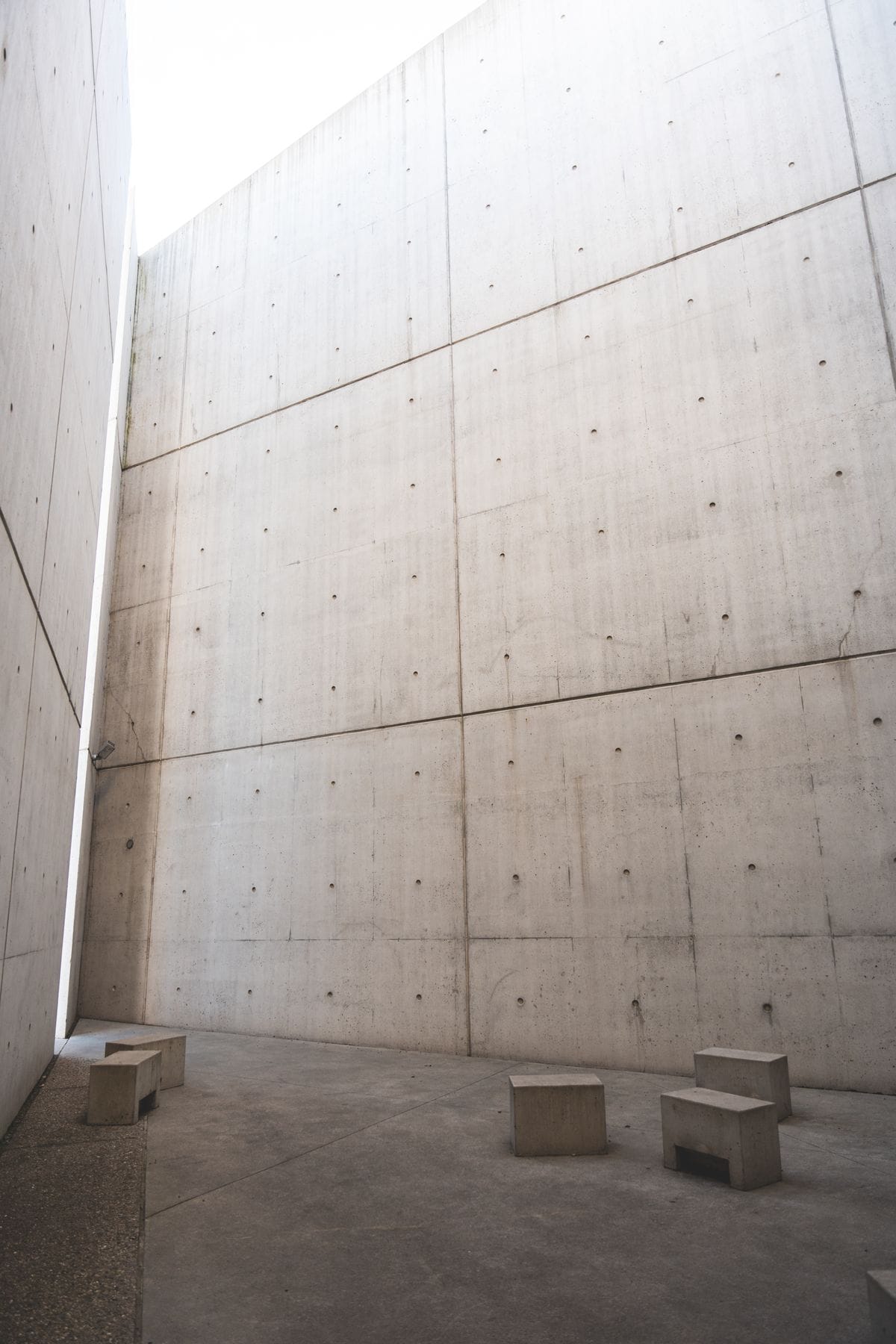 Minimalist concrete architectural space with tall walls