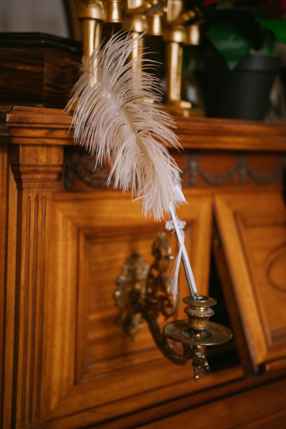 Feather quill pen resting on a vintage wooden desk