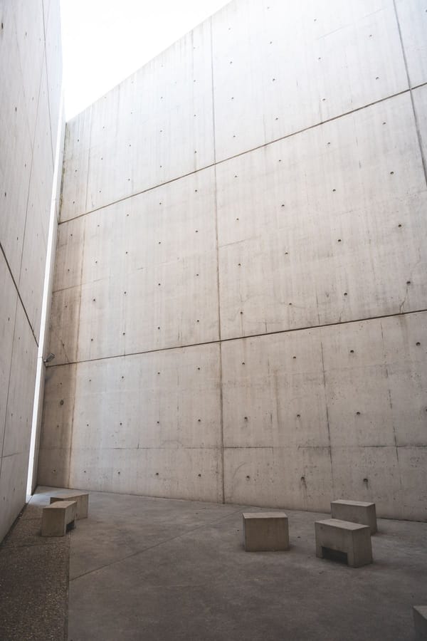 Minimalist concrete architectural space with tall walls