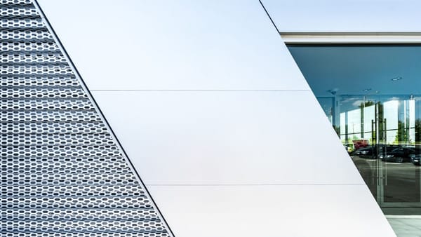 Modern white concrete building with geometric facade