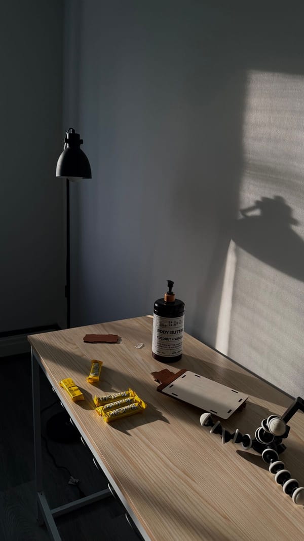 Minimalist desk with lamp casting hard shadows