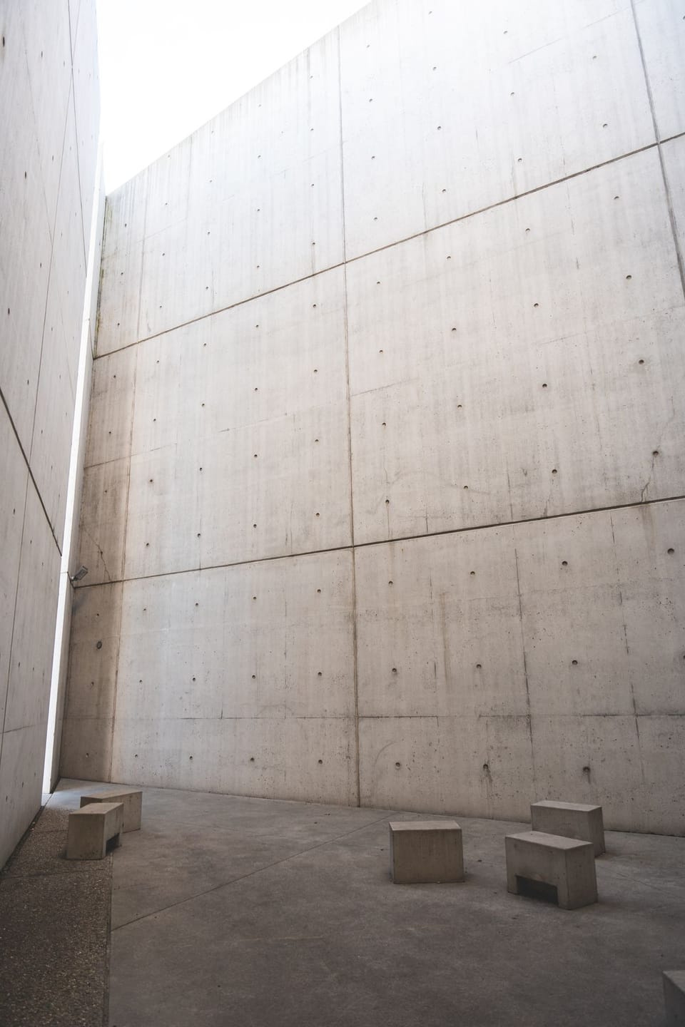Minimalist concrete architectural space with tall walls