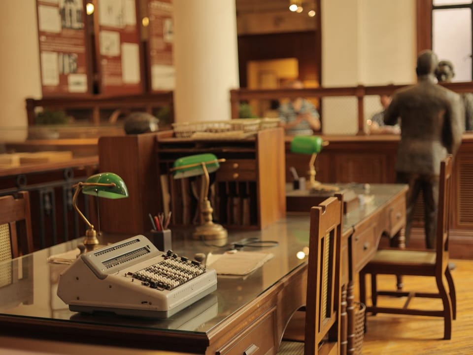 Vintage office interior with typewriter and green desk lamps