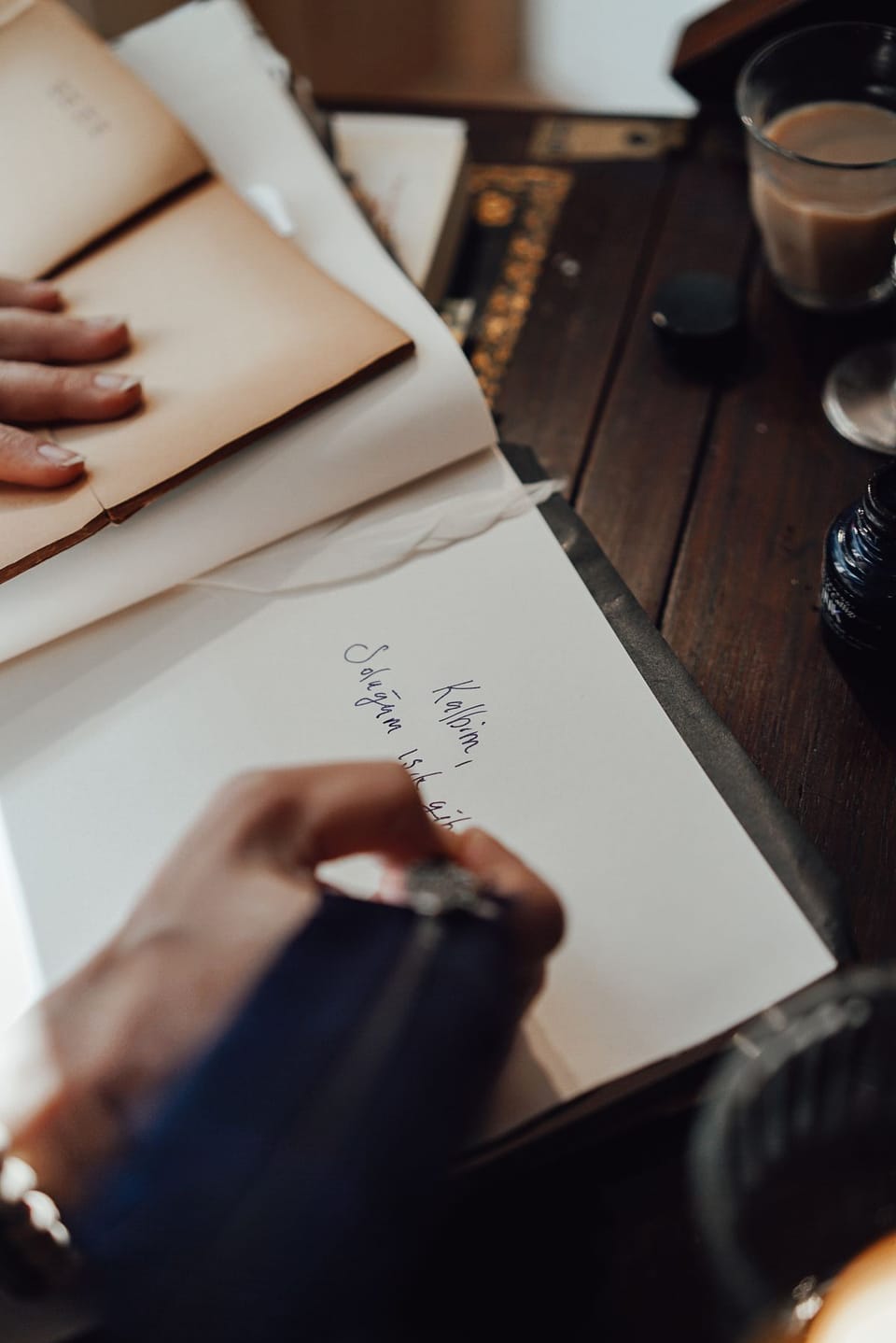 Overhead view of a writer taking notes with a feather pen